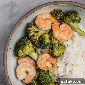 Bowl of roasted shrimp and broccoli.