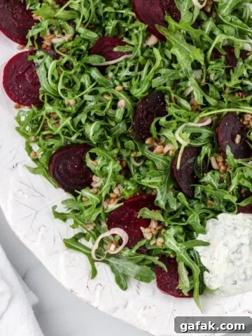 Roasted beet salad on a platter next to a napkin.