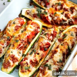 A baking dish full of cheesy stuffed zucchini.