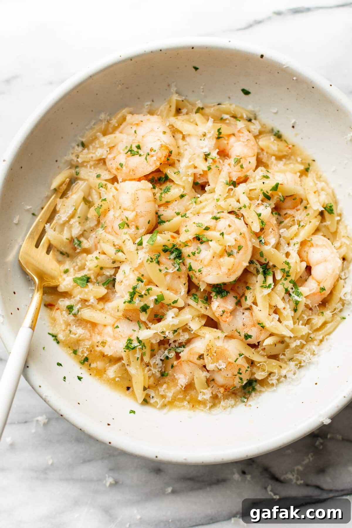 Creamy Shrimp Scampi with Lemon Orzo 2 a bowl of shrimp scampi orzo with a fork