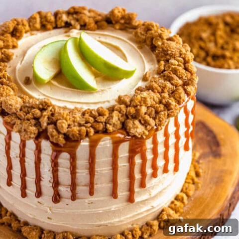 caramel apple crumble cake on a wooden cake stand