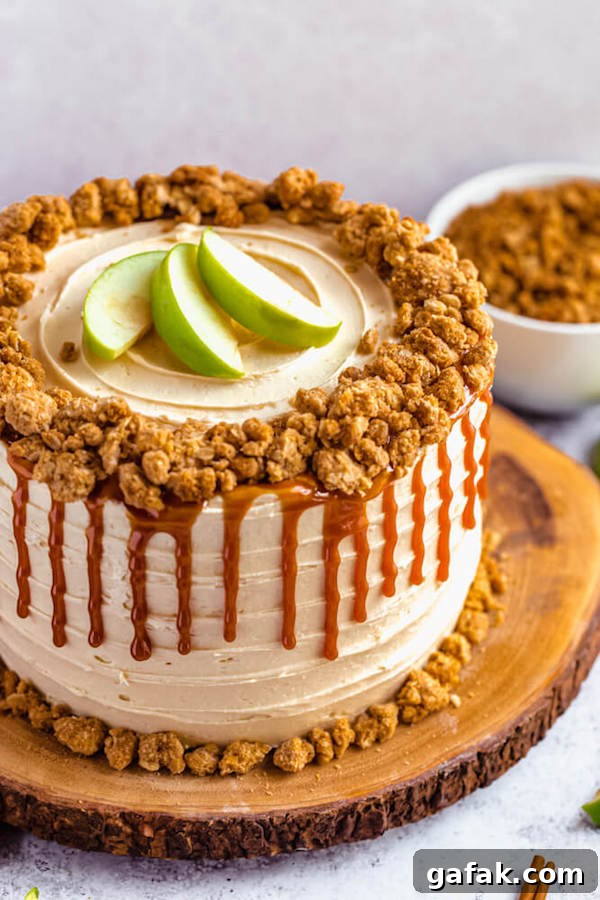 caramel apple crumble cake on a wooden cake stand