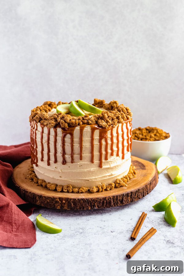 caramel apple crumble cake on a wooden cake stand