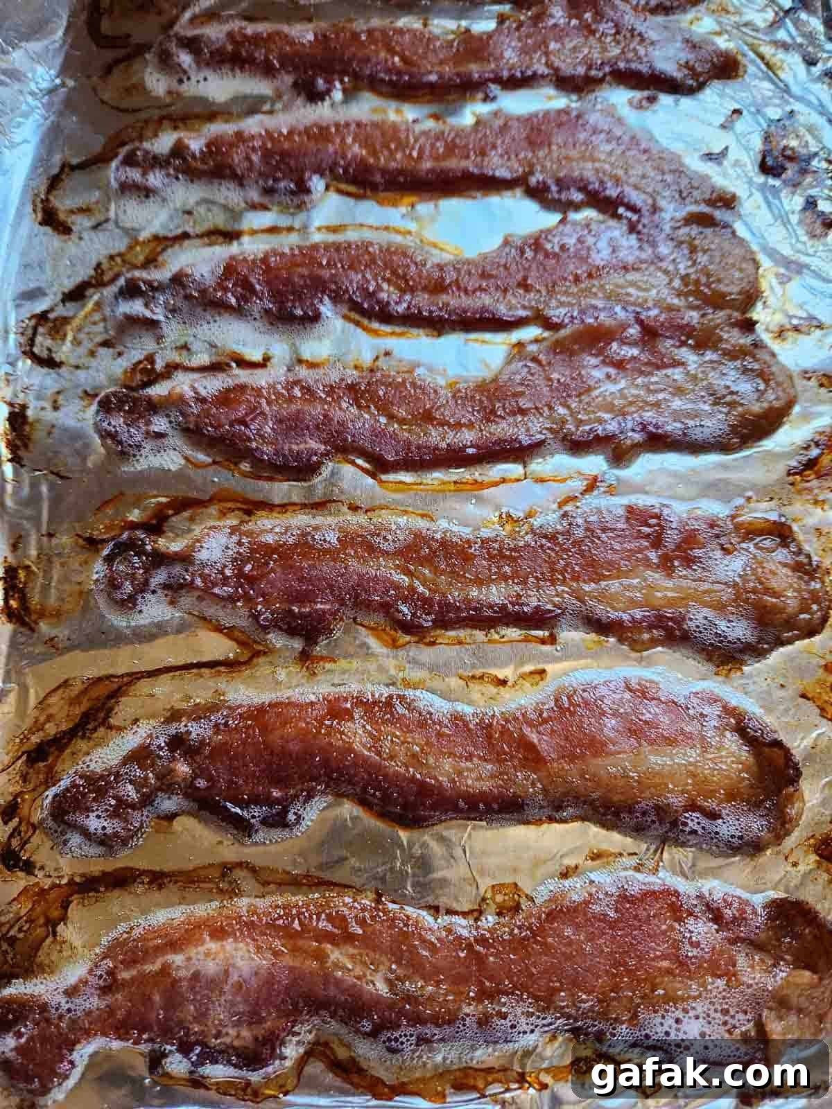 Cooked bacon on a sheet pan.