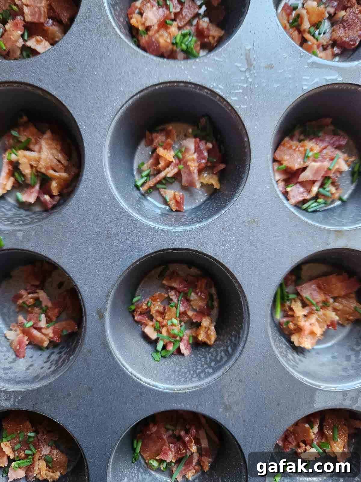Bacon and chives in a muffin tin.