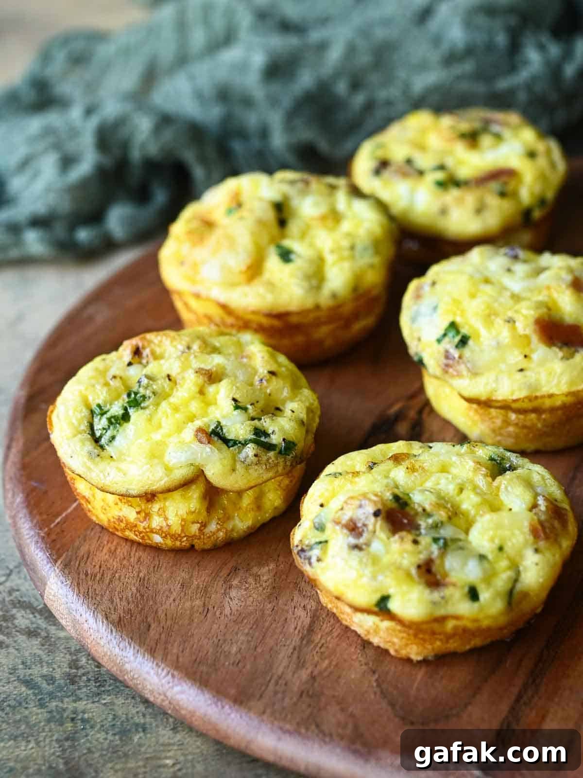 Five egg bites on a wood board.