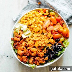 Ingredients of the salad assembled together in a white bowl.