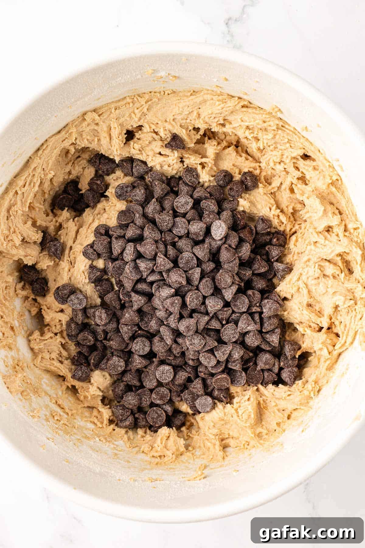 Vegan Chocolate Chip Cookie Recipe: Crispy Outside, Chewy Inside 11 adding chocolate chips to the batter