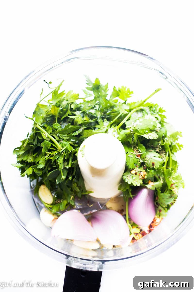 My 5 minute chimichurri sauce has a secret ingredient that sets it apart from the rest! It comes together in just a few minutes with a couple of pulses in the food processor. This sauce packs loads of garlicky flavor and is a perfect sauce, marinade and dip for just about anything!
