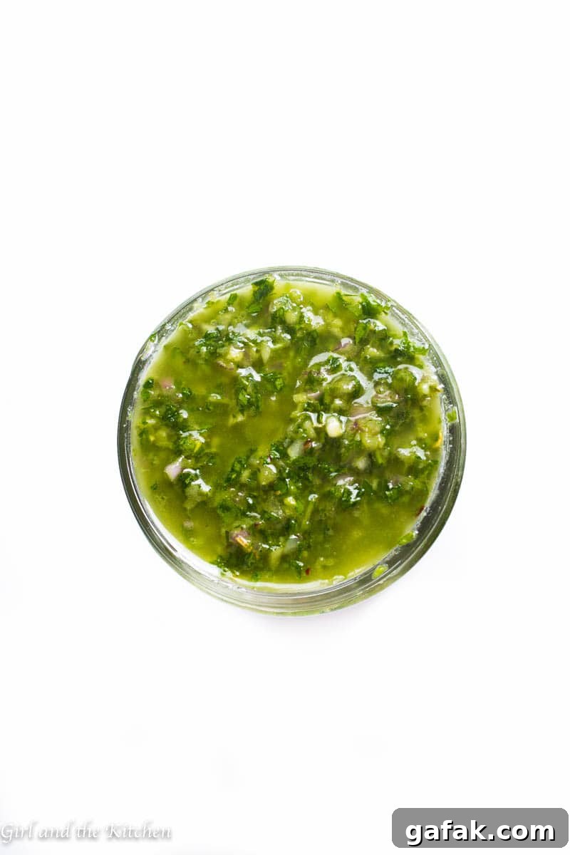 My 5 minute chimichurri sauce has a secret ingredient that sets it apart from the rest! It comes together in just a few minutes with a couple of pulses in the food processor. This sauce packs loads of garlicky flavor and is a perfect sauce, marinade and dip for just about anything!