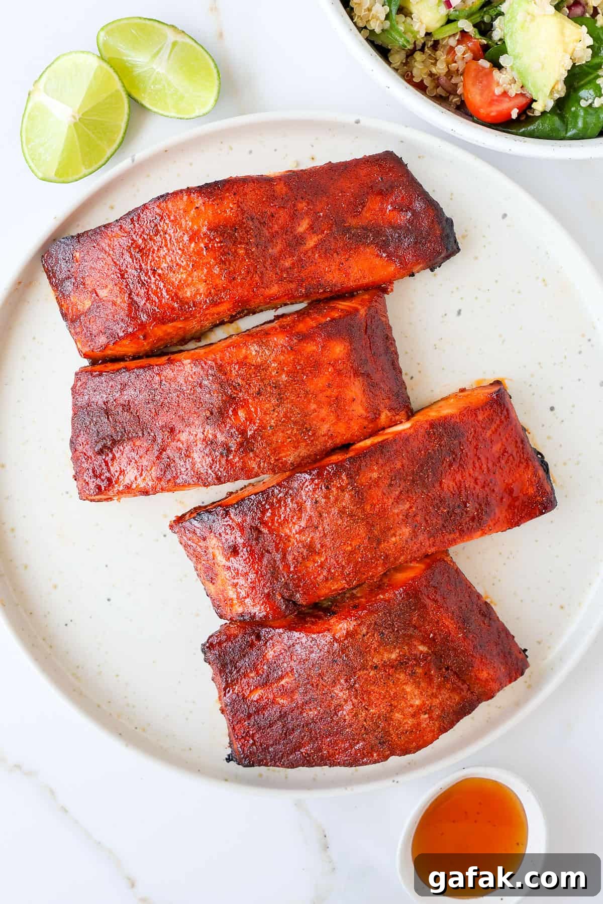Grilled honey paprika salmon filets on a plate.