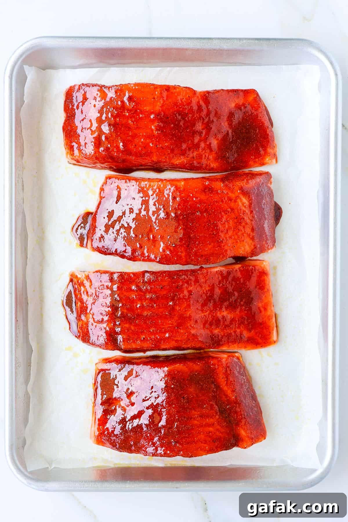 Honey paprika glazed salmon filets on a sheet pan.