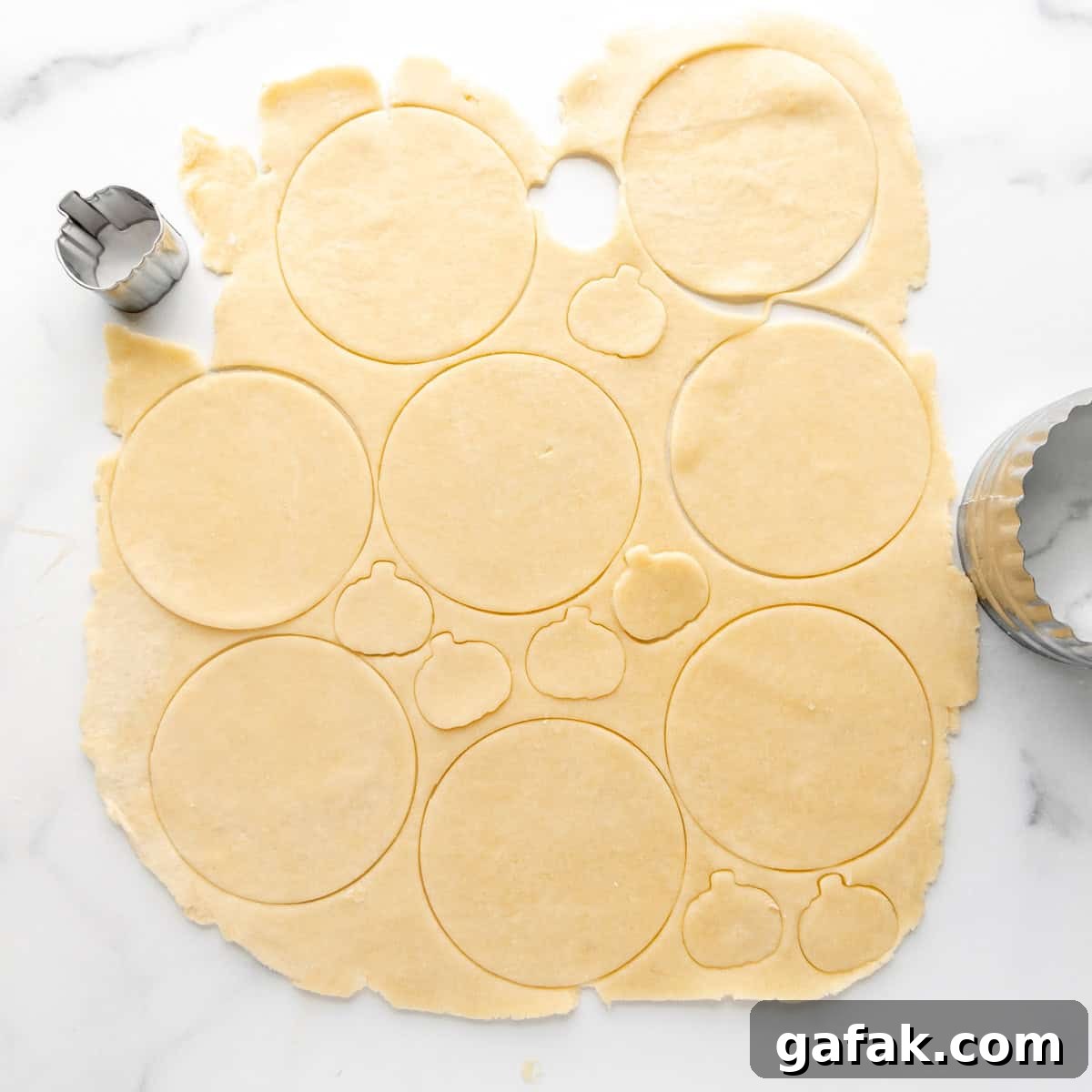 Mini Pumpkin Hand Pies: Flaky Autumn Pastry Recipe 5 Overhead image of circles cut out of pie dough.
