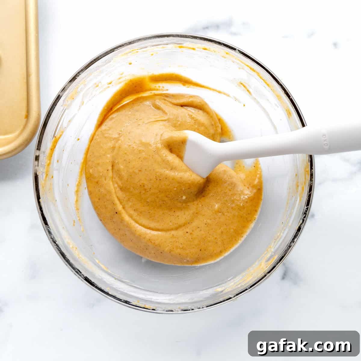 Mini Pumpkin Hand Pies: Flaky Autumn Pastry Recipe 8 Smooth pumpkin filling in a clear bowl with a white spatula.