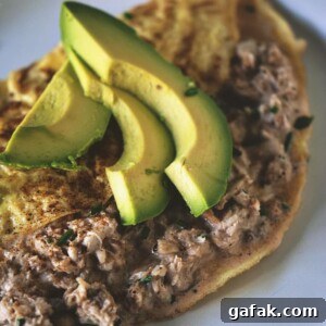 A crab omelet featuring avocado, served on a plate.