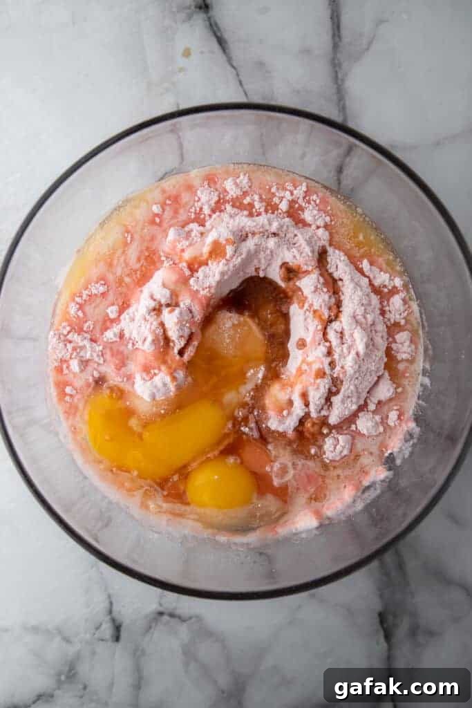 Strawberry brownie batter ingredients mixed in a bowl
