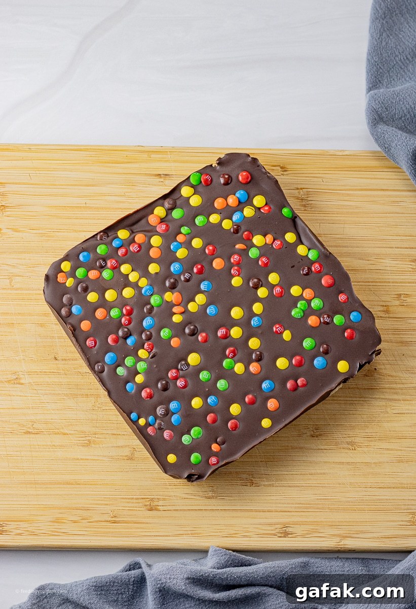 No-Bake Chocolate Chip Cookie Dough Bars Recipe for Dessert 4 no bake cookie dough bars topped with chocolate and mini colored candies