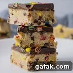 square cookie bars stacked on a white plate