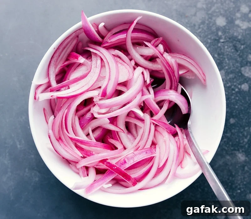 Pickled onions in a bowl, ready to be used as a topping.