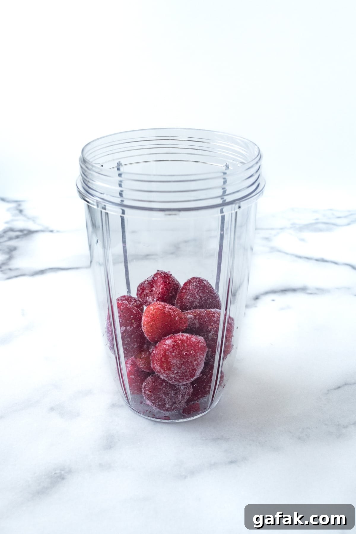 Frozen strawberries in a blender.