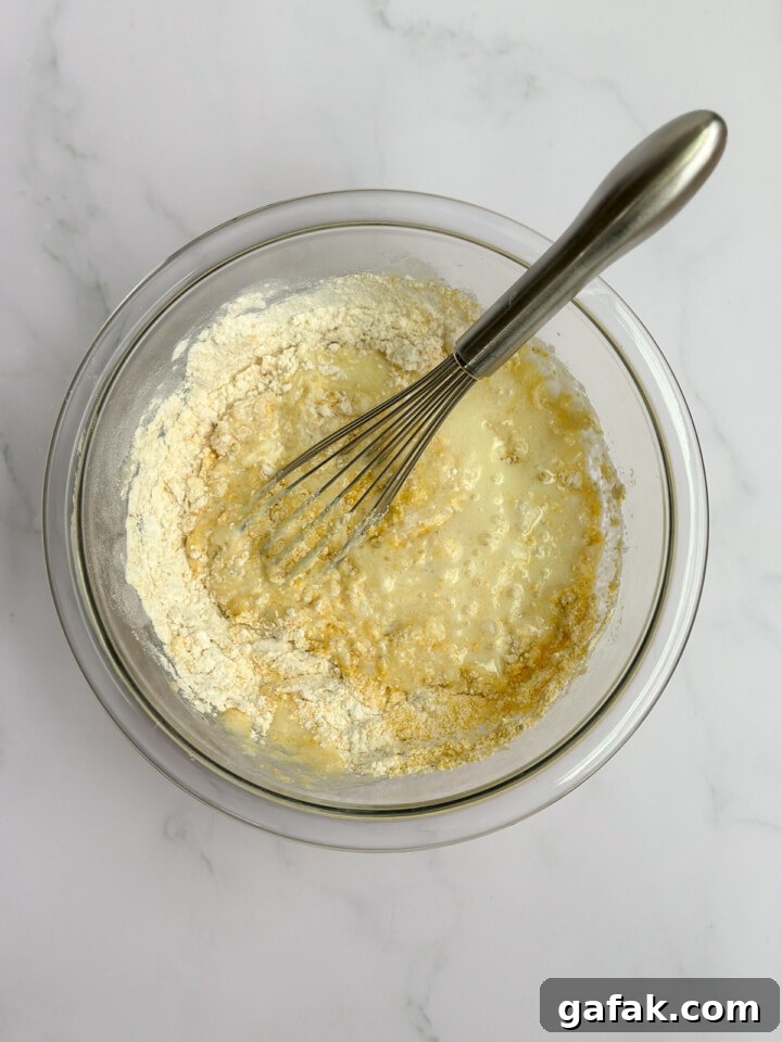 whisking in dry ingredients.