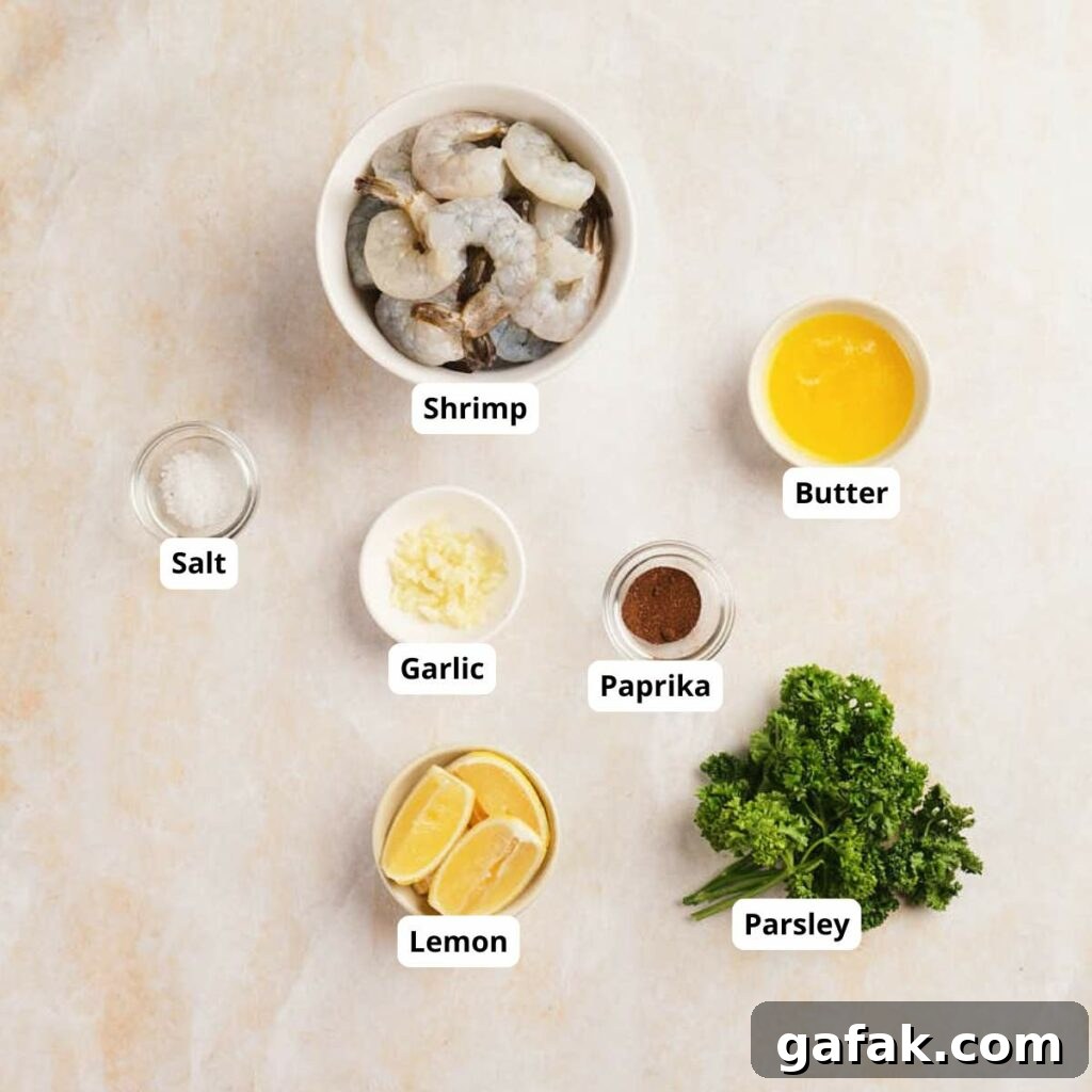 Top-down view of garlic butter shrimp labeled ingredients on a light surface.