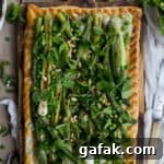 Charred asparagus tart with baby leeks, peas, pea shoots and fresh herbs | via @annabanana.co