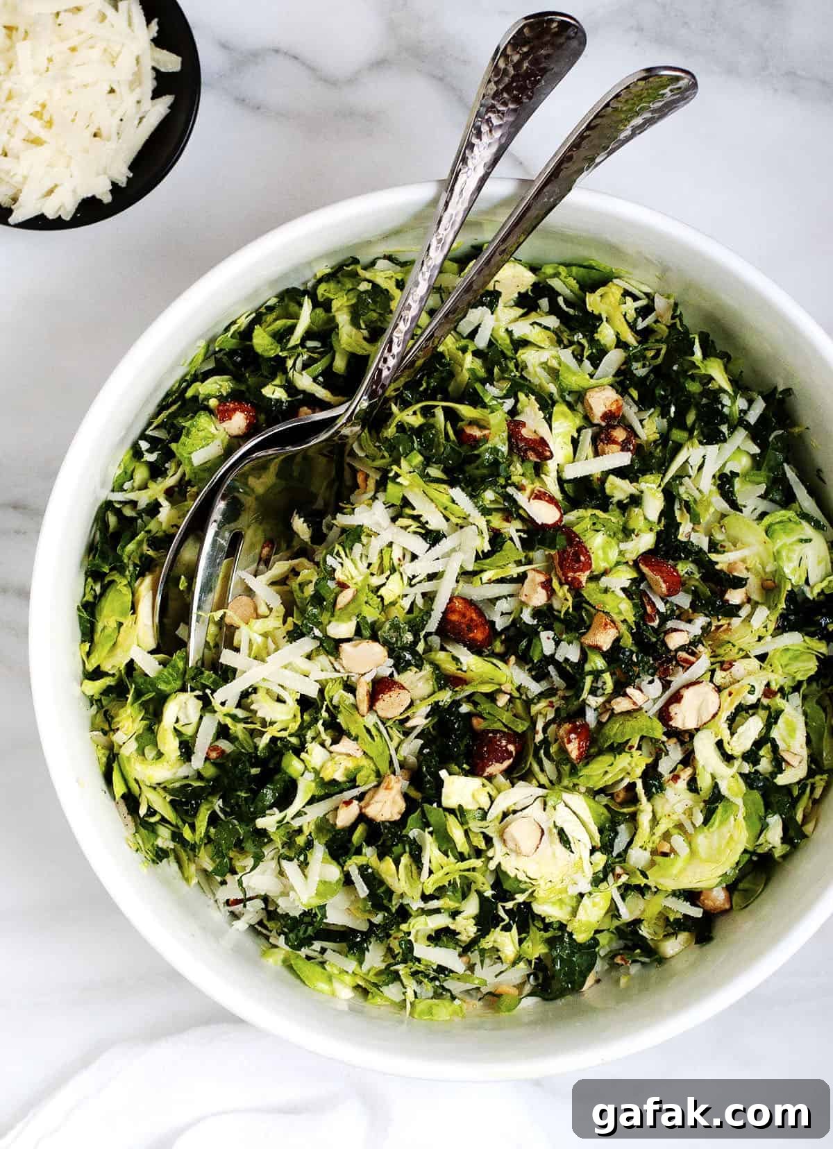 Kale and Brussels Sprout Salad served in a white bowl