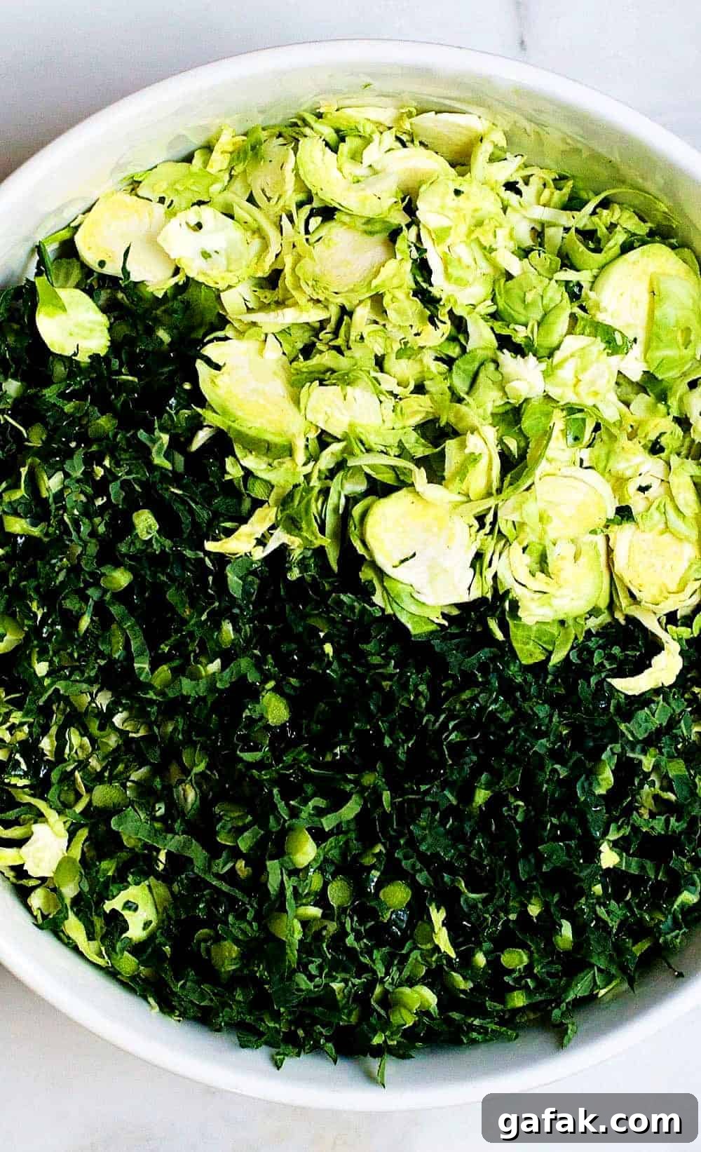Thin-Sliced-Kale-and-Brussels-Sprouts in a white bowl