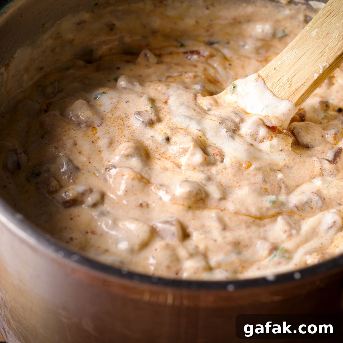 Creamy Mushroom Lasagna with Parmesan Béchamel Sauce 11 Stirring mushroom ragù into a pot of parmesan béchamel.