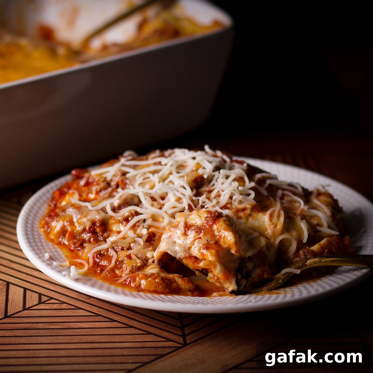 A plate with a serving of lasagna bolognese on it.
