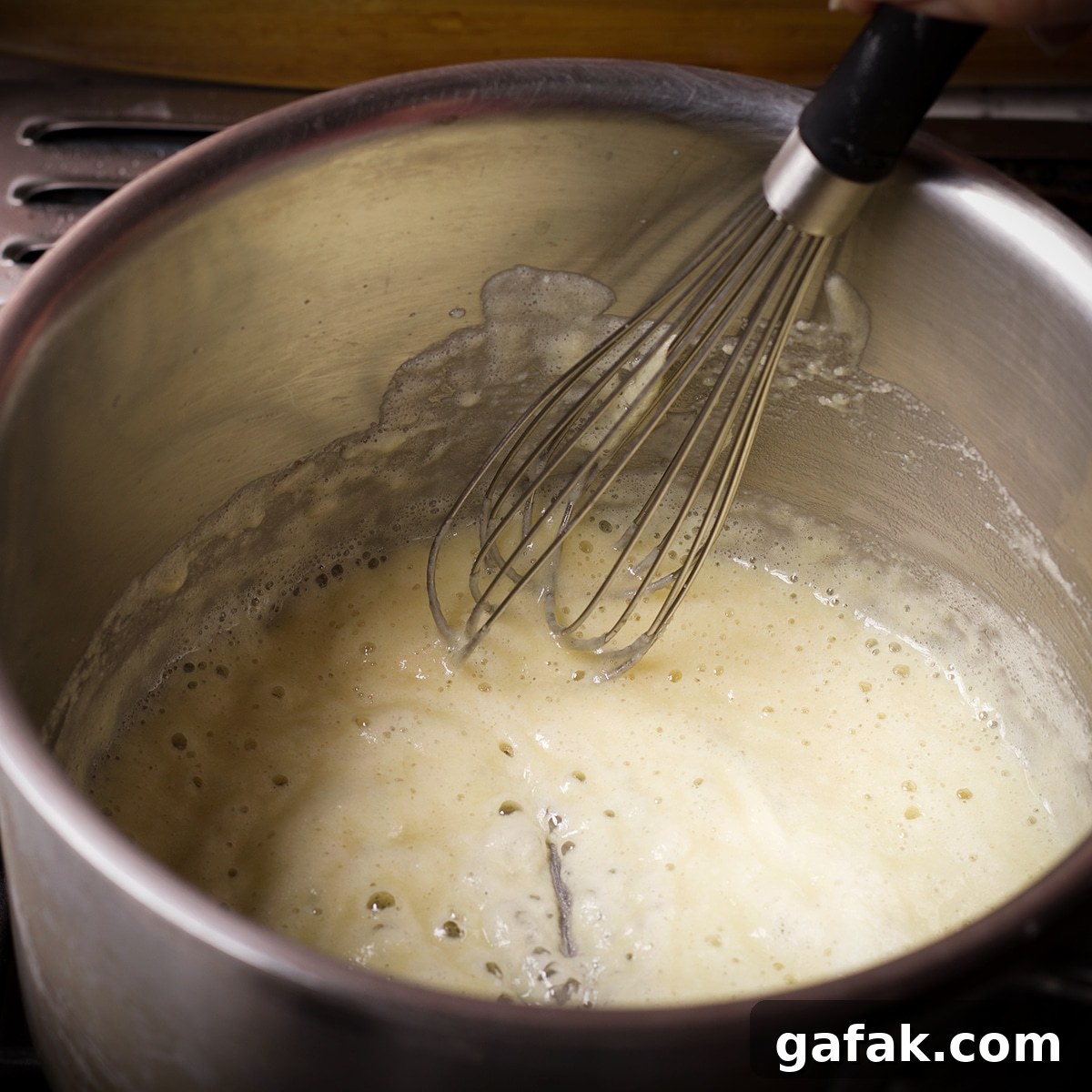 Creamy Mushroom Lasagna with Parmesan Béchamel Sauce 5 Flour and butter cooking in a saucepan on the stovetop to make a roux.