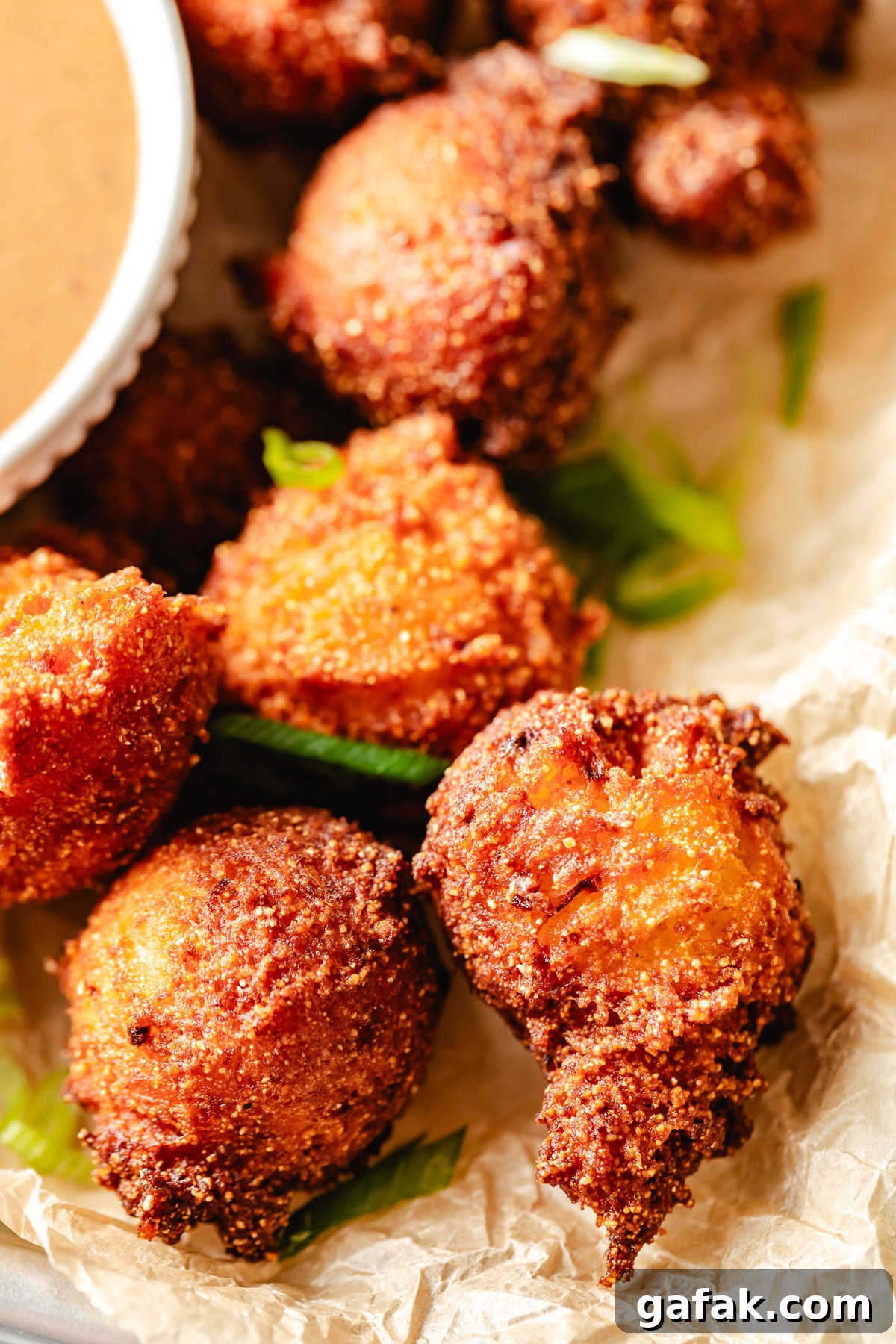Fried hush puppies on parchment.