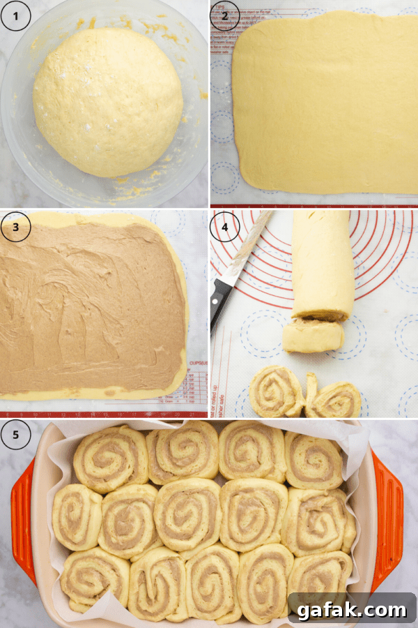 proofed cinnamon roll dough being rolled out and spread with filling before rolling it up and slicing it into buns