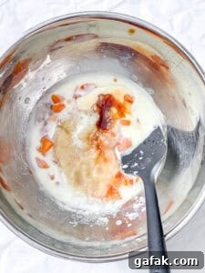 process shot showing mixing wet ingredients in a bowl