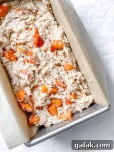 process shot showing batter for persimmon bread in bread pan