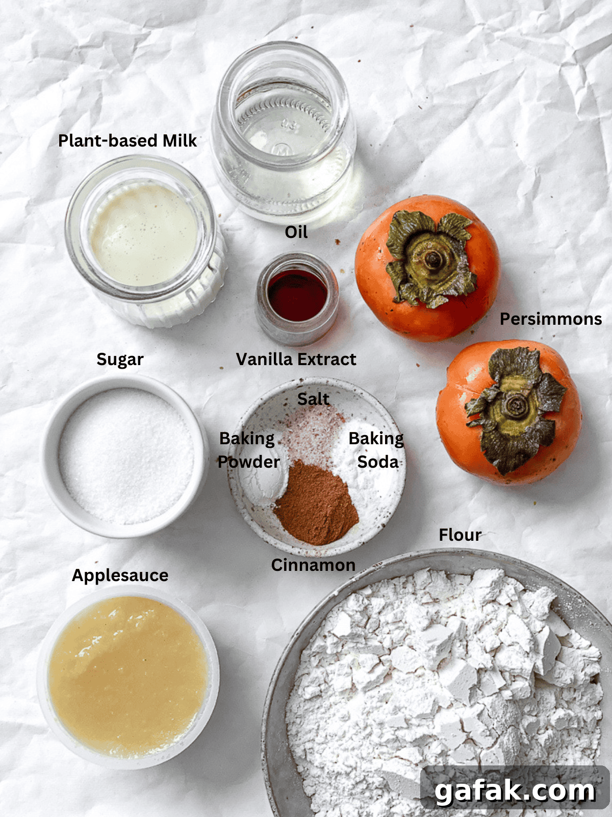 process shot showing ingredients for Easy Persimmon Bread on a white surface