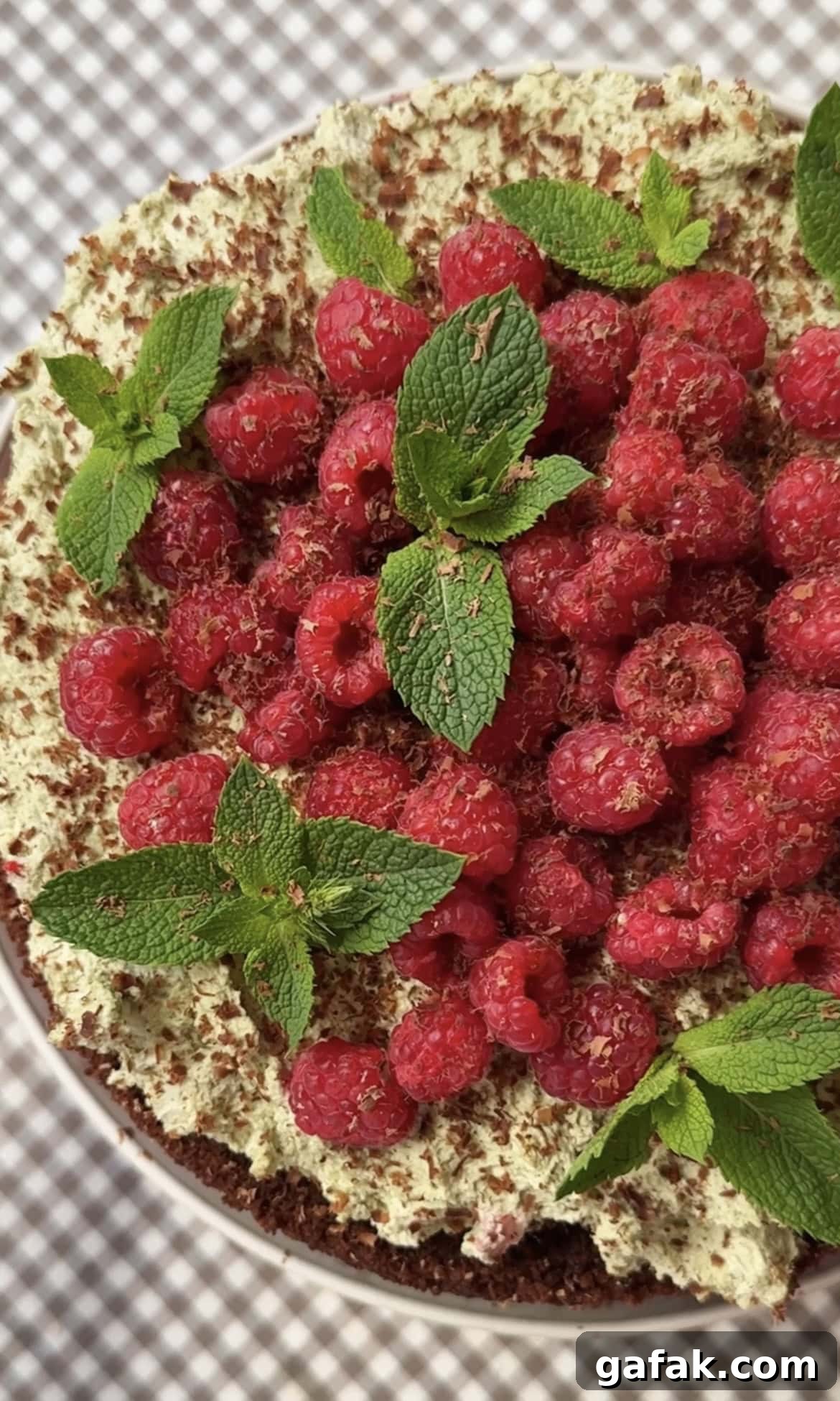 adding decoration to raspberry chocolate cake.