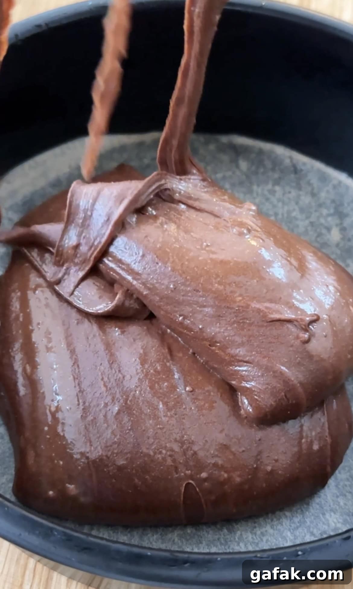 splitting cake batter into the cake tins.