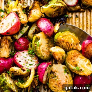 Close up shot of halved Roasted Brussels Sprouts and Radishes on a baking sheet