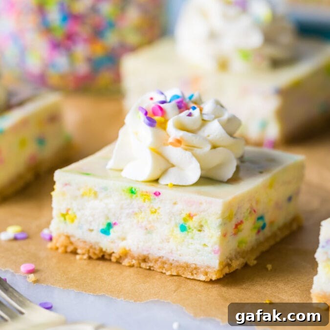 funfetti cheesecake bar topped with whipped cream and sprinkles on brown parchment