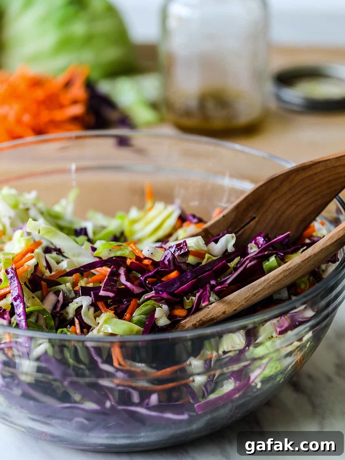 A bowl of coleslaw on a kitchen counter.