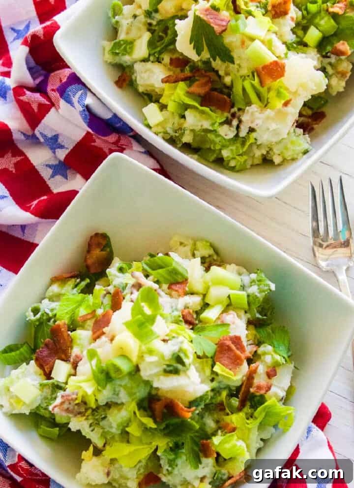 Bacon potato salad in a small white bowl.