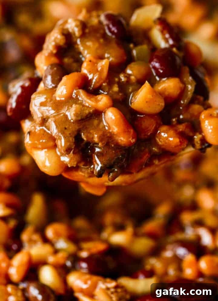 Spoon serving cowboy baked beans.