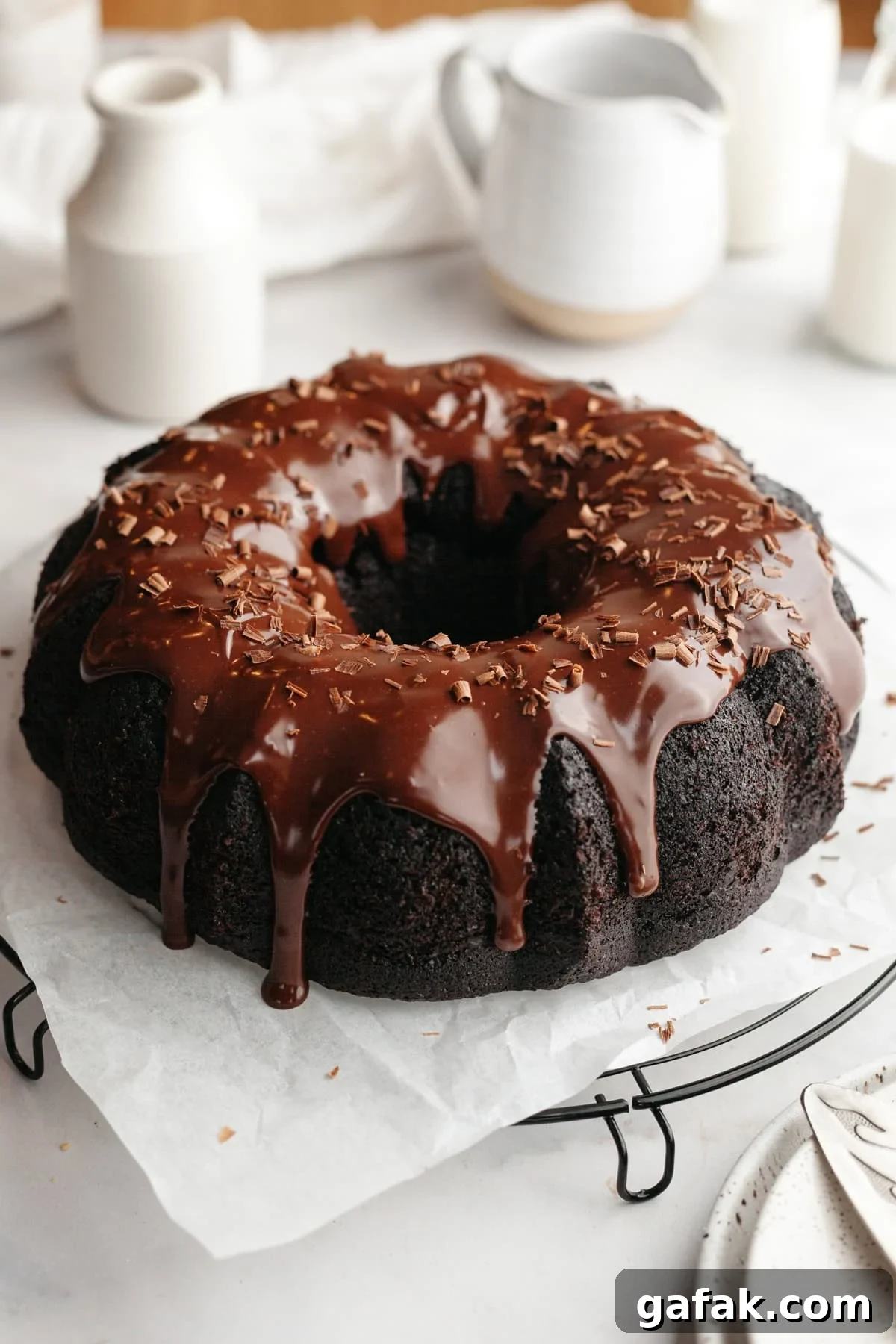 A chocolate bundt cake covered in chocolate ganache.