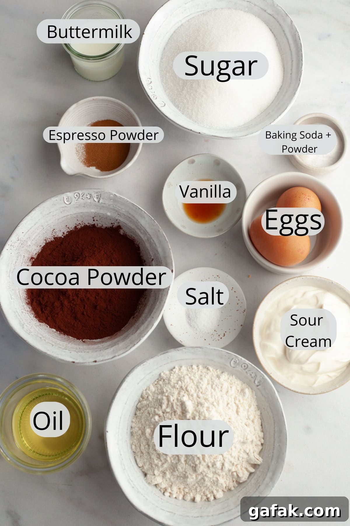 All the ingredients needed to make a chocolate bundt cake, weighed out into small bowls.