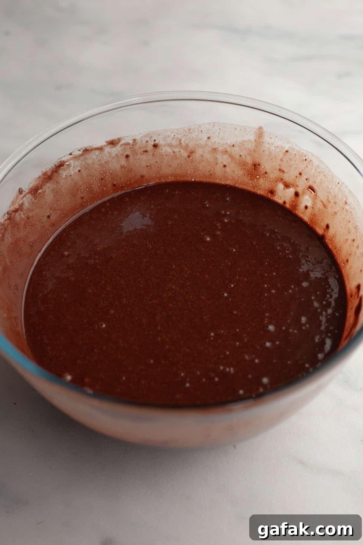 Chocolate cake batter in a bowl.