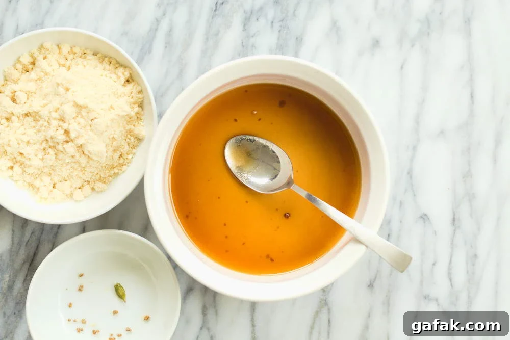 Sugar mixture for our Vegan Almond Halwa in a white baking dish