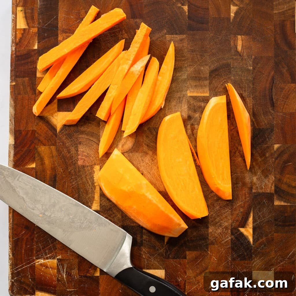 chopping sweet potatoes on cutting board