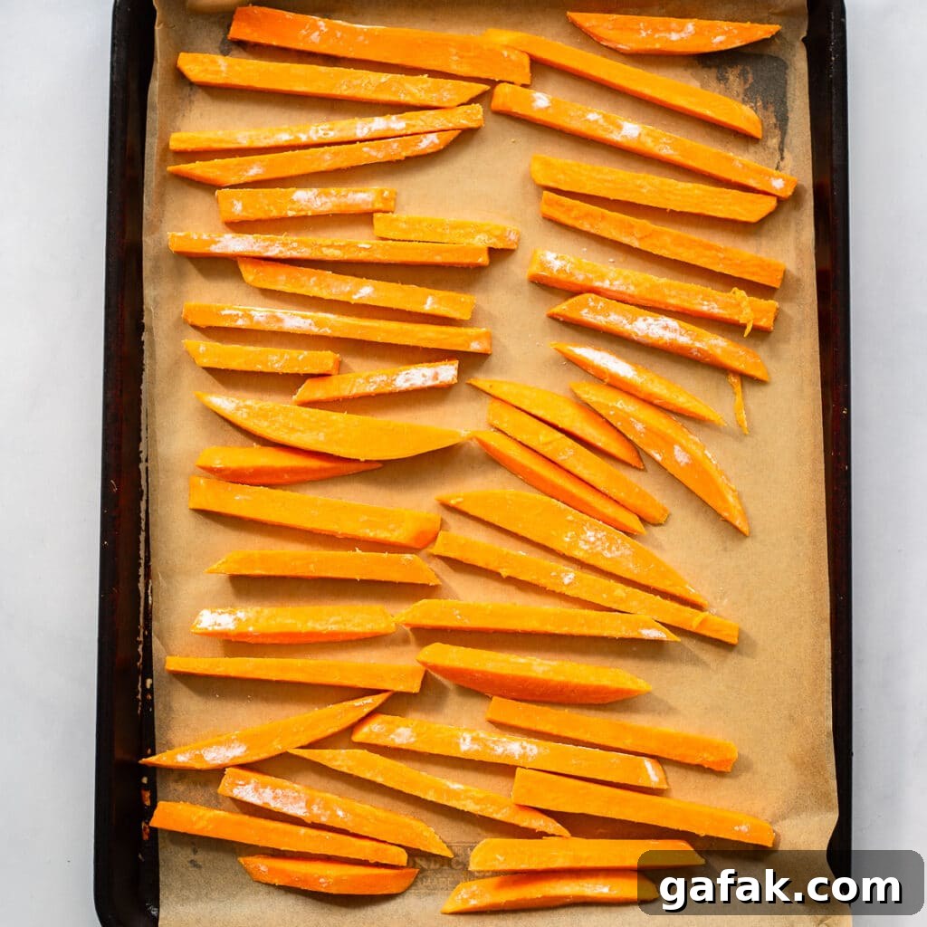 prepped sweet potato fries on baking sheet